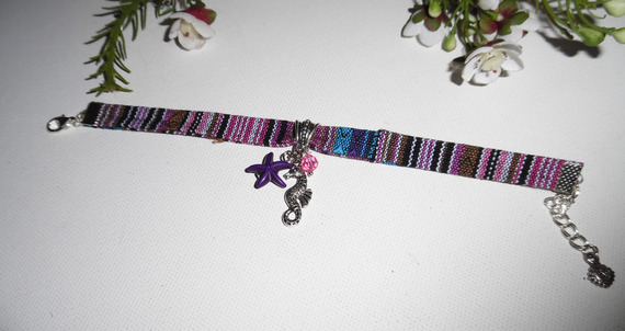 Pulsera de tela de colores con borlas de caballito de mar y estrella de mar morada